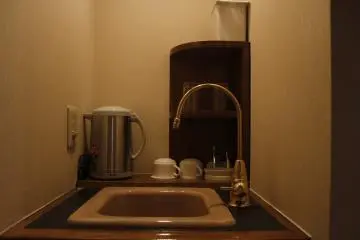 <p>The sink with the kettle and coffee maker.</p>