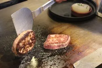<p>Preparing steaks on the hotplate</p>