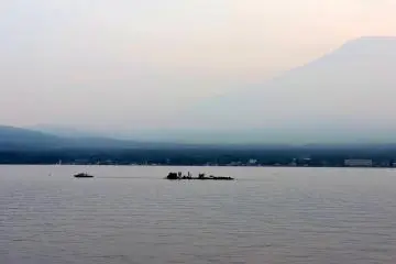 A small boat towed barges laden with fireworks onto the lake