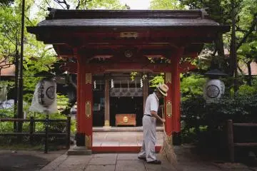 Grounds keeper sweeping the path for the gods to walk