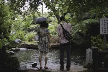 <p>In a world away from the city, feeding the Koi</p>