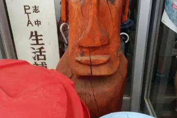 One of my favorite moai hiding behind some trash bins at a neighborhood association community hall