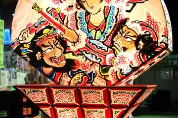 <p>Fan-shaped Neputa lanterns with the paintings near a gas station</p>