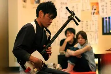 <p>Performing the Tsugaru Jamisen</p>