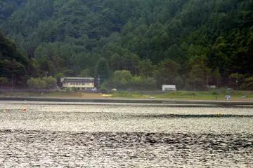 <p>The lake is surrounded by forested hills</p>