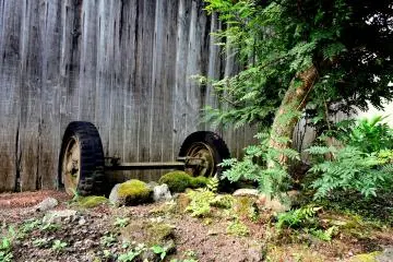 <p>Abandoned axel beside an old wooden shed</p>