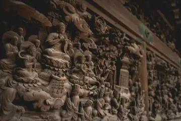 <p>Intricately carved walls based on Lotus Sutra, inside the temple</p>