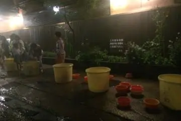Buckets filled with hot spring water from hotels for guests and spectators to throw on the shrine. (Photo: Sarah Elisabeth Chaney)