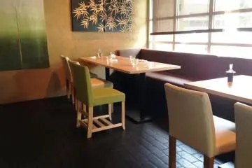 The simple matcha green chairs and bamboo prints are pleasing on the eye.