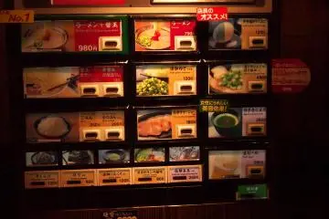 <p>Ticket machine has item names in English and Japanese, along with pictures of the item you're trying to order.</p>