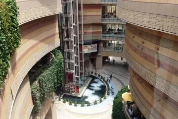 <p>The curved lines of Namba Parks glow with various hues of pink as the sun moves across the sky.</p>
