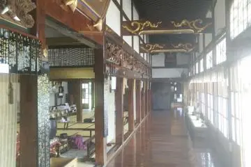 The corridor outside the main hall is beautifully decorate with plenty of carvings and polished wood floors.
