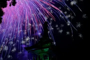 Fireworks behind a stone lantern