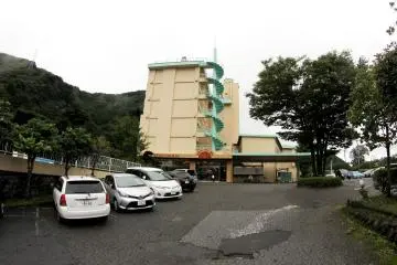 This is the entrance to the hotel as seen from across the street, with a parking lot in front of it.&nbsp;