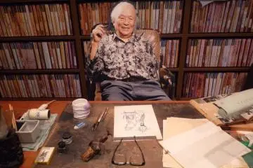 Mizuki Shigeru (photo cut-out) of him sitting behind his drawing desk