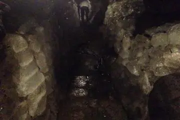<p>Inside the ice cave: ice resembling crystal formations surrounding all walls</p>