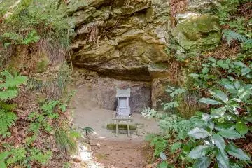 <p>A 'Yagura' (cave), containing a mini shrine</p>