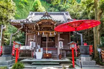 <p>The main shrine building surrounded by some colorful red lanterns and banners</p>
