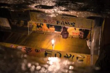 <p>Reflection of a food stall in a puddle</p>