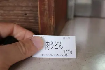 <p>The vending machine gives you a ticket like this which you give to the people at the window</p>