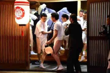 <p>Lion and his bearers rushing inside a newly-built house to expel evil spirits</p>