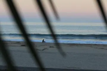 Lonely surfer reflecting on his day