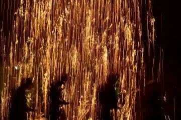 The falling gunpowder explodes as it rains down.