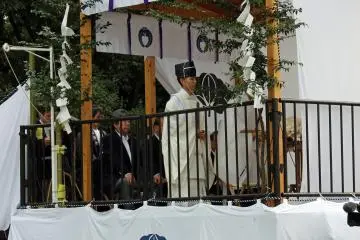 Two monks from Kasuga Shrine officiate the prayer ceremony with participation from officers of the Nara Park Office