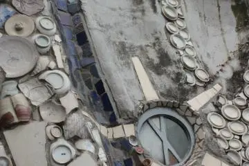 <p>A very close look at the exterior of St. Philip Church will reveal broken cups and dishes from Europe and China embedded in the concrete as part of the design.</p>