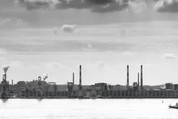 Moody scenes passing dockside industrial zones