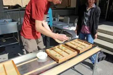 <p>Finally a thin application of pulp to seal the decorations into the paper</p>