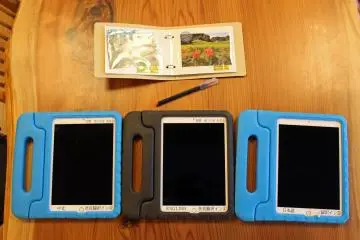 <p>Three of the Visitor Center's tablets (Chinese, English and Japanese language), and the Asuka Village photo album</p>