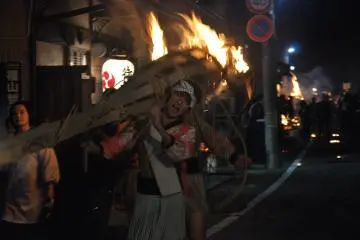 <p>Les participants crient tout en marchant avec la torche sur leurs &eacute;paules</p>