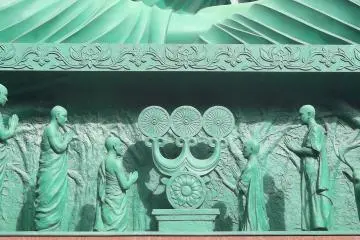 <p>Devotees at the Buddha's base</p>