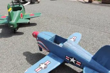 <p>A collection of really cool wood-carved vehicles (airplanes, tanks, bicycles) sit in front of the museum and are free for kids to ride around in.</p>