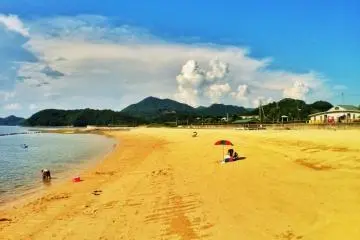 An expanse of sandy beach and blue sky