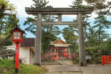 The main building of the shrine, framed by a stone gate