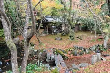 <p>A stone bridge leads across the small pond</p>