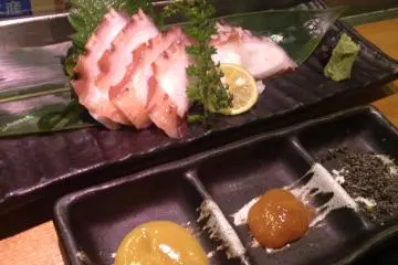 <p>Slices of octopus with various types of dipping sauce</p>
