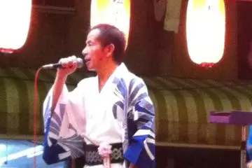Traditional style singer on the stage at the centre of the dancing