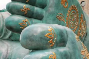 The holy teachings on the statue's soles
