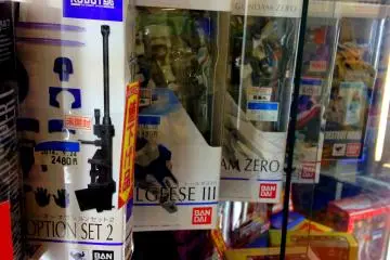 <p>Several action figures are on glass display</p>
