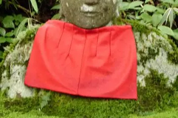 Moss covered Jizo stone statue