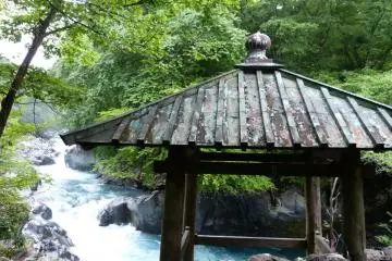 The prayer platform sits on a rock jutting out over the river
