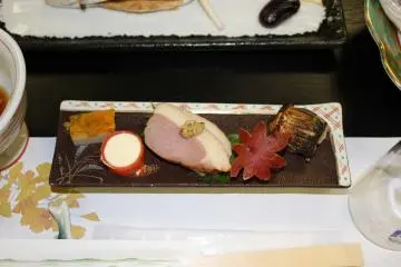 <p>Egg, salmon lox wrapped cream cheese, duck breast with mustard, sweet potato carved like a maple leaf and vegetable stuffed fish</p>
