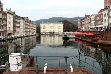 <p>A canal is lined with European buildings</p>
