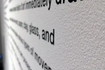 <p>Paragraphs of info. about Gehry are posted on the wall.</p>
