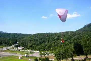 An advanced student begins a turn after taking off from the top of the intermediate hill