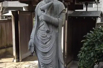 She stands close to the gate