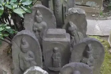A cluster of weather-worn figures by the gate